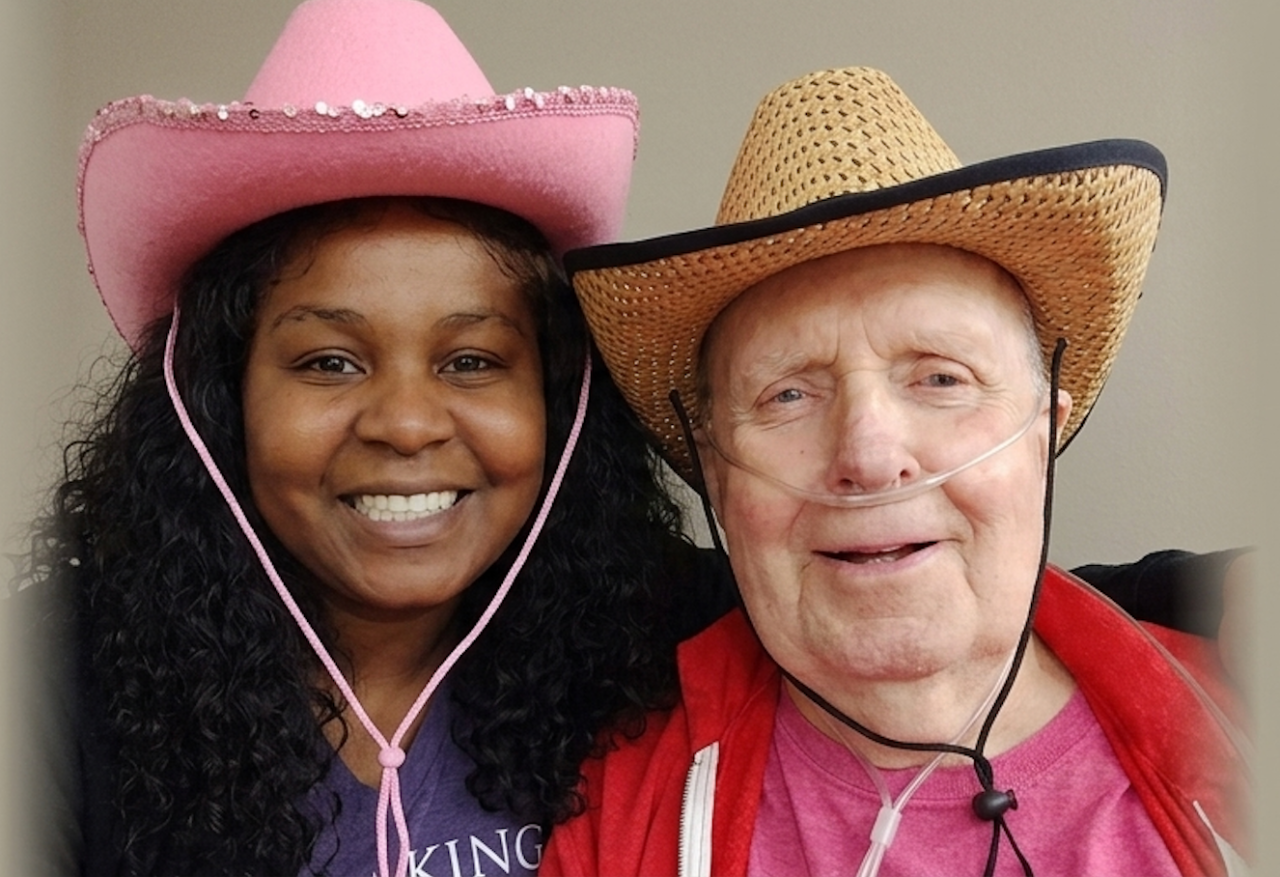 Loving Arms caregiver with a senior client wearing matching cowboy hats